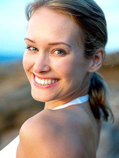 blond woman at beach smiling nice teeth after cosmetic dentistry Beverly Grove Los Angeles, CA cosmetic dentist
